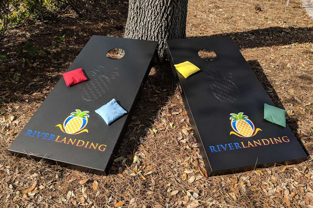 River Landing commercial cornhole set with full color logo and custom engraved logo | R&R Commercial Game Tables